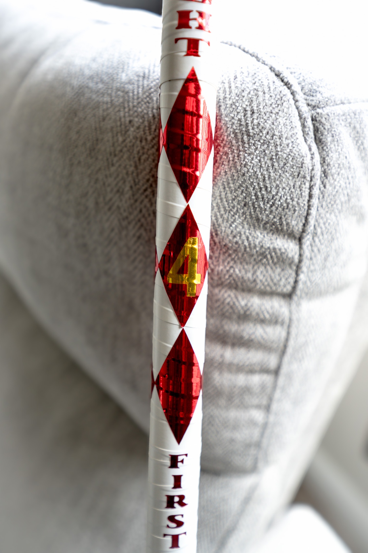 Close-up of red diamond number 4 detail on First Klass cane